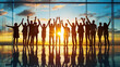 © Yuwarin - Silhouette of a happy group of people with arms raised in a success