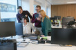 © Caia Image - Employees looking at computer in office