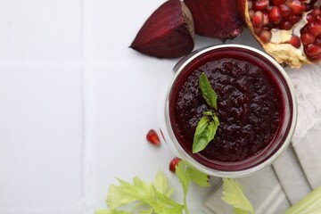 Wall Mural - Fresh beetroot smoothie with mint, beet and pomegranate on white tiled table, flat lay. Space for text