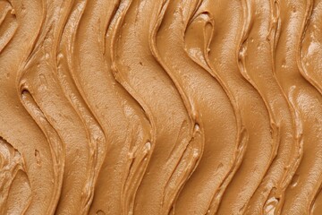 Wall Mural - Tasty peanut butter as background, top view