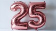 © Hashir - A balloon with the number 25 in rose gold color.