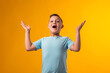 © Aleksej - Surprised child boy with opened mouth on yellow background.