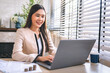 © lovelyday12 - woman is sitting at a desk with a laptop and a cup of coffee