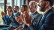 © sirisakboakaew - A group of happy business people applauded the speakers sitting in a row in a conference room. Successful colleagues and company employees applaud their colleagues at training or business meetings.