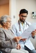 © RGShirtWorks  - Doctor discusses medical report with elderly patient in a clinic during a routine check-up