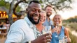 © LifeMedia - A group of friends enjoying a joyful evening together outdoors, radiating happiness, camaraderie, and celebration, with warm lighting enhancing the festive atmosphere.