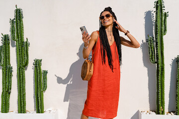 Wall Mural - stylish pretty woman with african braids on sunny summer vacation