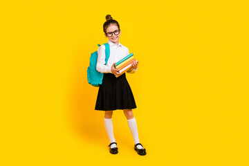 Sticker - Full size photo of cute schoolgirl hold book empty space wear uniform isolated on yellow color background