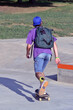 © Gustavo Andrade - Skateboarder boy wearing backpack skating on outdoors park.