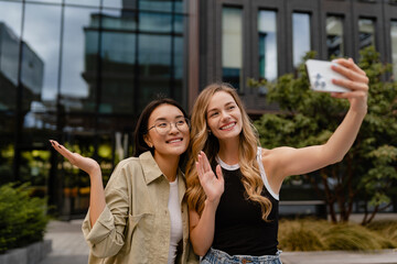 two young pretty women students in street