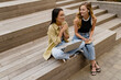 © mary_markevich - two young pretty women sitting in student campus co-working outside