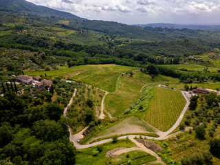 Aerial drone view of vineyards and hills in Tuscany, Italy. Mountain range near city Lucca.