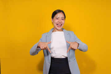 Young professional woman is confidently pointing at herself with both index fingers, showcasing her self assurance and positive attitude