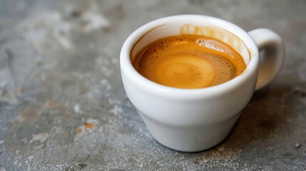 Poster - A single espresso shot in a small white cup, with crema on top.