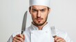 © orendesain99 - A chef is holding a knife and fork in his hands