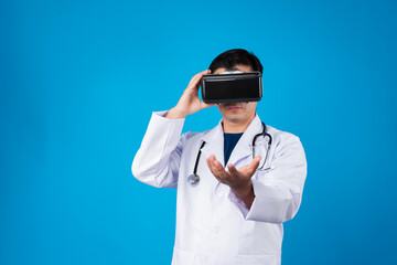 Wall Mural - Smart doctor wearing VR headset looking to connect metaverse data holding analytical medicine research isolated blue background futuristic technology hologram virtual reality meta world. Contrivance.