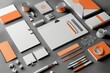 © Iftikhar alam - Orange and white stationery set arranged neatly on a plain grey background, Incorporating branding elements into promotional materials