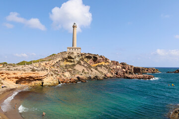 Beautiful Cabo de Palos lighthouse and Cala Fria beach on a sunny day of summer