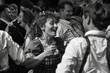 © Iftikhar alam - A group of people standing in a circle, joyously dancing and laughing as they celebrate, Joyous dancing and laughter as people celebrate the spirit of Oktoberfest