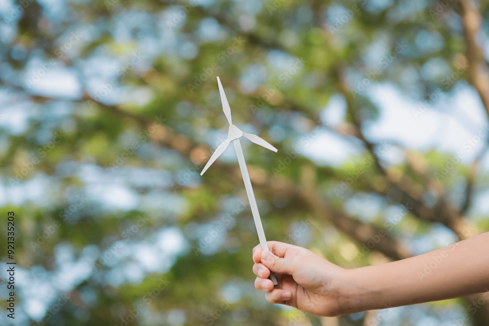 Windmill Boy Little boy holding windmill or wind turbine mockup model to promote eco ...