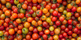 red, yellow and green tomatoes in the market