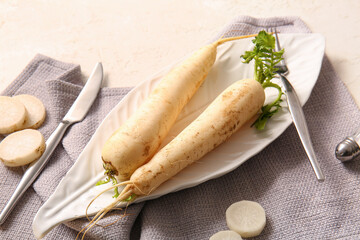 Wall Mural - Plate with fresh daikon radishes on white background