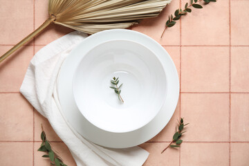 Sticker - White plates with dry palm leaf on pink tile background