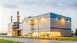 © LunaStar - Modern industrial building with evening lights, advanced manufacturing facility exterior