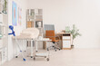 © Pixel-Shot - Interior of medical office with massage therapist's workplace and couch