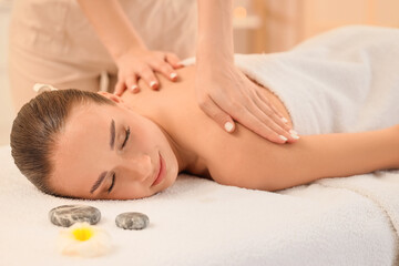 Canvas Print - Beautiful young woman undergoing treatment by therapist in spa salon