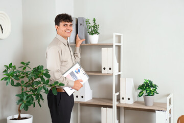 Poster - Male accountant with clipboard taking folder in office