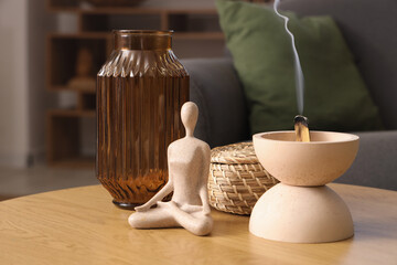 Poster - Bowl with Palo Santo, statuette and vase on table in living room, closeup