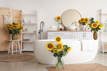 Canvas Print - Sunflowers in vases in interior of bathroom