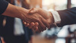 © Mahemud - Office Handshake: Man and woman shaking hands in an office setting, symbolizing collaborative
