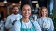 © Lens Legacy - A smiling woman in an apron stands in a busy restaurant with her team in the background, embodying hospitality, teamwork, and a friendly atmosphere.