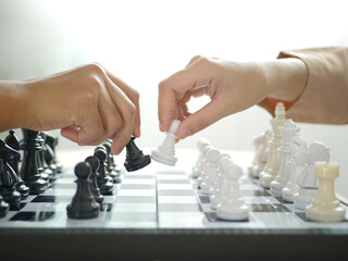 two business women play a game of chess to be a concept of busin