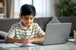 © N7 - 'Indian Boy Doing Homework at Home' - An Indian student working on homework, illustrating dedication to studies.