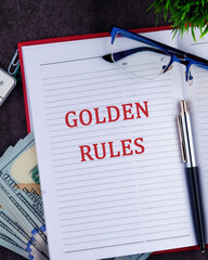 Wall Mural - Conceptual golden rule symbol. Copy space. GOLDEN RULES words in a notebook, a vertical photo