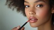 © Watasiwa - Close-up of a woman applying lip liner with precision
