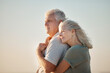 © peopleimages.com - Relax, beach and senior couple hug with love, care and support for anniversary holiday or date outdoor. Sea, calm and commitment of elderly people with retirement and space on vacation in Greece