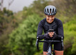 © Michael Cunningham/peopleimages.com - Cycling, woman or bicycle with phone in nature for navigation app, tracking workout progress or reading notification. Athlete, person or happy with smartphone on bike for cardio exercise or direction
