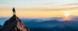 © Cheewynn - Person at the pinnacle of a mountain, with a breathtaking sunrise, representing guidance in career advancement and self-improvement