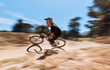© Michael Cunningham/peopleimages.com - Extreme sports, nature and blur of man on bicycle for training, workout and exercise on trail. Fitness, cycling and person on mountain bike for adventure, cyclist and adrenaline with speed movement