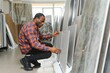 © Serhii - African american man customer choosing ceramic tile at building materials store