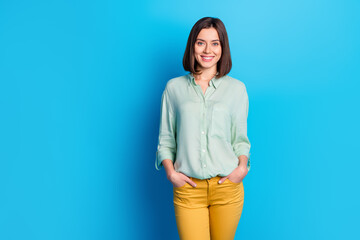 Wall Mural - portrait of confident lovely cheerful girl with stylish hair wear teal shirt hold hands in pockets i