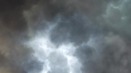 thunderstorm and lightning on the black clouds in sky.