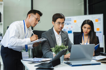 Wall Mural - Businessmen team or financial data analysts working with tablets and laptop computers and data graphs together. Plan to analyzing projects in the office.