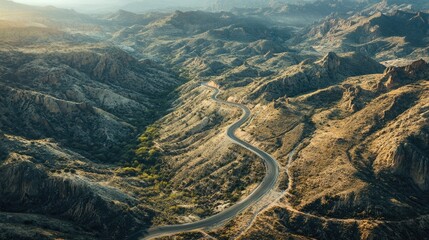 Wall Mural - Top view of a winding road with dramatic elevation changes through rugged mountain terrain. Ideal for adventure and travel imagery