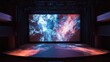 © P.G - A theater stage with a large projection screen showing abstract visuals during a performance.