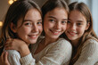 © Victoriia - Group portrait of three smiling hugging girls, teenage friendship, happy sisters family photo